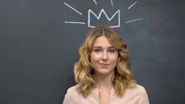 Smiling lady with magic wand standing near chalkboards with crown drawing, fun — Stock Video