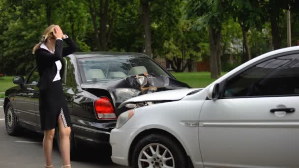 Mujer frustrada observando daños en el coche después de la colisión trasera en el estacionamiento — Vídeos de Stock