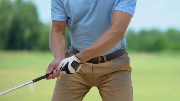 Young man feeling sharp pain in shoulder hitting ball playing golf, massaging — Stock Video