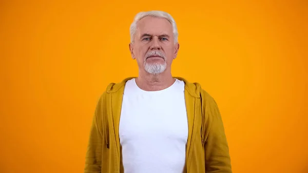 Serious Senior Man Looking Camera Isolated Yellow Background Insecurity — Stock Photo, Image