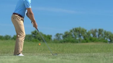Adam golf oyuncusu delik içine topu koymak için kısa mesafe isabet yapma, pratik