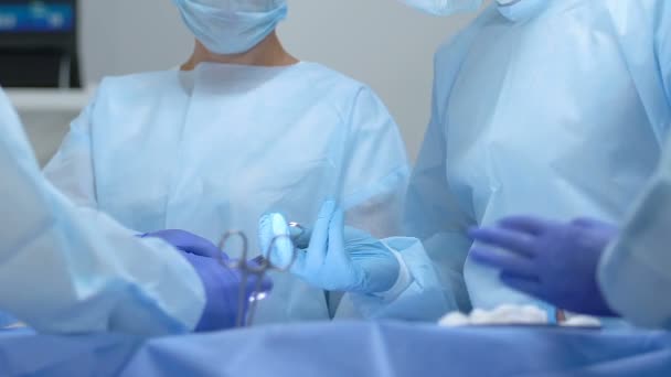 Verpleegkundige assisteren arts tijdens het gebruik, plastische chirurgie, liposuctie procedure — Stockvideo