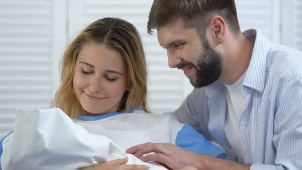 Felicidad de padres jóvenes contentos mirando al recién nacido, trabajo de hospital, paternidad — Vídeos de Stock