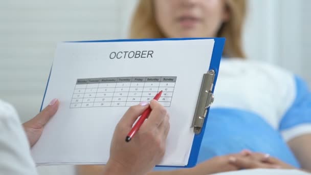 Врач отмечает дату в календаре говорить пациентка, рак молочной железы осведомленности — стоковое видео