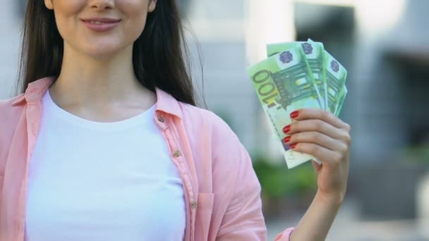 Joyful pretty female holding euro banknotes, bank deposit, cash back service — Stock Video