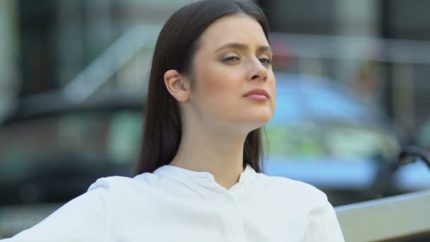 Attractive young female sitting city bench outdoors, enjoying work break, peace — Stock video