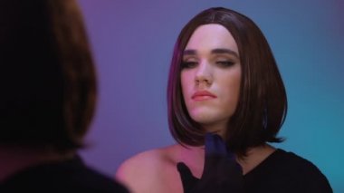 Travesti püskürtme parfüm ve gülümseyen ayna yansıması, cinsiyet kimliği