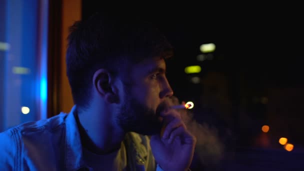 Depressed man nervously smoking near window at night, life decision, problems — 图库视频影像