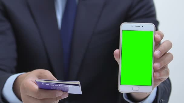 Manager showing passport and smartphone with green screen, electronic visa app — Stockvideo