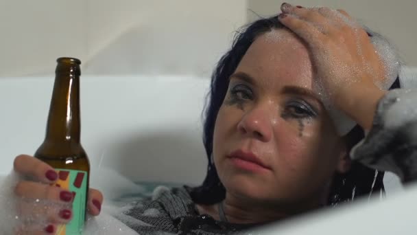 Sick female clubber suffering hangover drinking beer bottle lying bath, crisis — Stock Footage Sick female clubber suffering hangover drinking beer bottle lying bath, crisis Stock Video