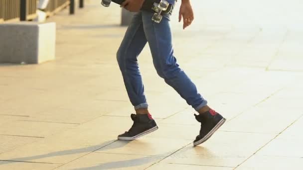 Teenage boy with skateboard dancing outside, having fun, street performance — Stock Video