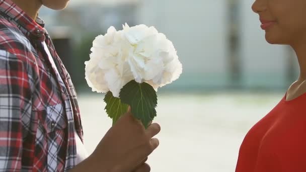 Adolescente chico presentando novia ramo de flores, invitando para romántico fecha — Vídeo de stock