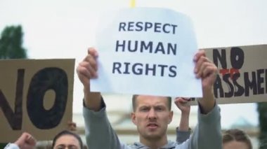 Halk, şiddete karşı taciz yok, insan haklarına saygı için slogan atıyor.