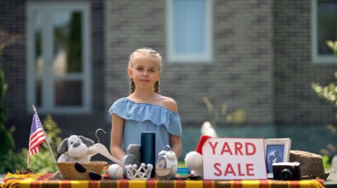 Young business lady selling old toys on yard sale, earning extra pocket money clipart