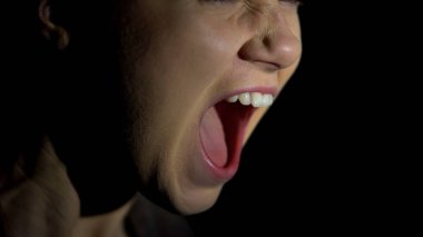 Face of female screaming against dark background, psychological problems clipart