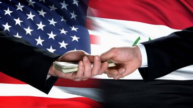 ABD ve Iraklı yetkililer para alışverişi, bayrak arka planı, ticaret ortaklığı