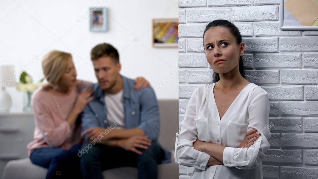 Desperate wife secretly listening husband with mother discussing relations
