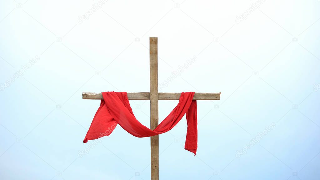 Wooden cross with red cloth wrapped around, crucifix and resurrection of Jesus