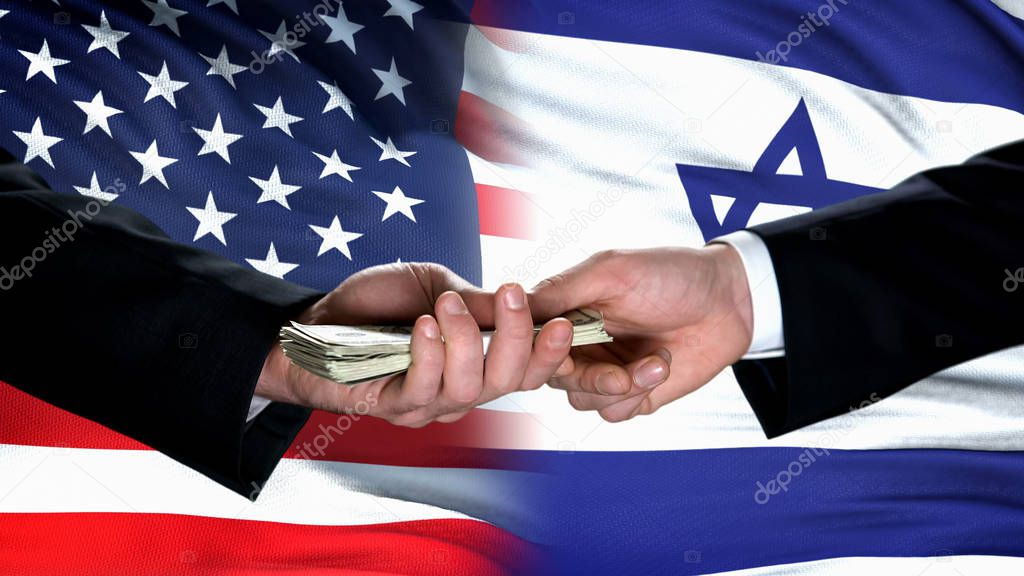 USA and Israel officials hands exchanging money against flag background, partner