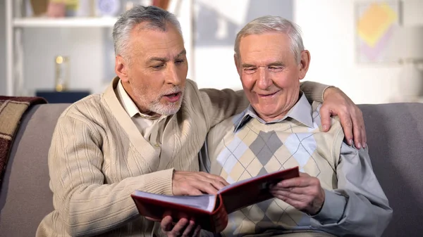 Happy Senior Brothers Watching Family Album Home Sofa Pleasant Memories — Stock Photo, Image
