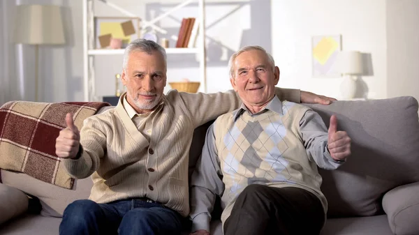 Χαμογελαστοί Παλιοί Φίλοι Κάθονται Στον Καναπέ Στο Σπίτι Δείχνοντας Τους — Φωτογραφία Αρχείου