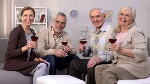 Envejecido Hombres Mujeres Sosteniendo Copas Vino Sonriendo Cámara Amigos Juntos —  Fotos de Stock