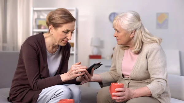 Seniorin Mit Smartphone Sitzt Mit Reifer Freundin Auf Sofa Freizeit — Stockfoto