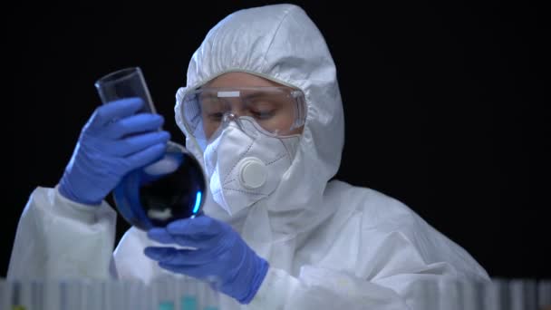 Lab assistant in protective suit examining poisonous fluid, ecology problems — Stock Video