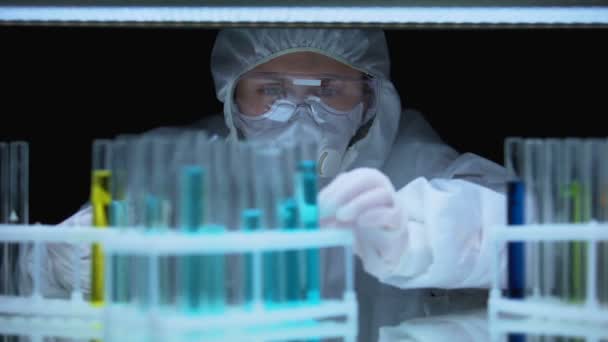 Професійний лаборант скидає рідину в пробірку, медичні дослідження — стокове відео