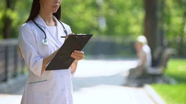 Mediziner Füllt Daten Krankenhauspark Frau Raucht Hintergrund — Stockfoto