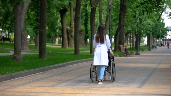 Női Ápoló Séta Parkban Fogyatékos Páciensek Számára Rehabilitációs Központ — Stock Fotó