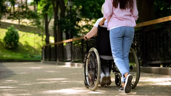 Tekerlekli Sandalye Hastane Bahçesinde Yaşlı Kadın Iterek Torunu Destek Bakım — Stok fotoğraf