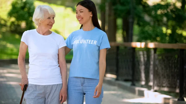 Sorrindo Mulher Voluntária Shirt Feliz Senhora Idosa Caminhando Jardim Repouso — Fotografia de Stock
