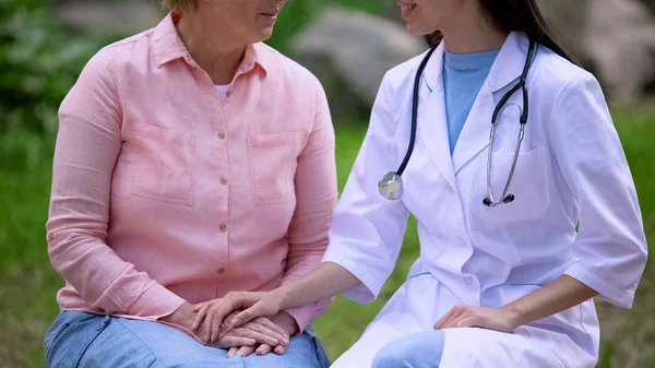 Vrouwelijke Arts Trooting Leeftijd Patiënt Zittend Ziekenhuis Tuin Kliniek Service — Stockfoto