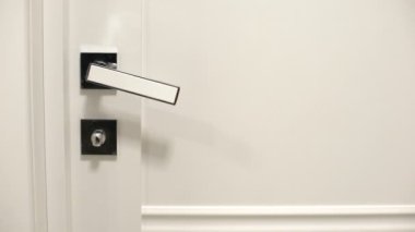 Female hanging sign on doorknob Please make up room, hotel cleaning services