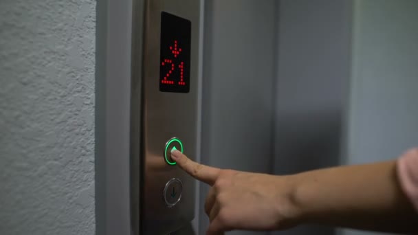 Finger pressing elevator button to upper floor, electronic LCD display, closeup — ストック動画