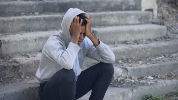 Pensive american millennial sitting alone thinking of problem, disappointment — Stock video