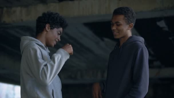 Adolescents noirs souriants frappant poings, geste d'amitié, camarades de classe saluant, amusant — Video