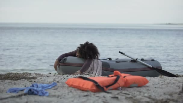 Distressed woman lying in boat waiting help, survived storm, natural disaster — Stock Video