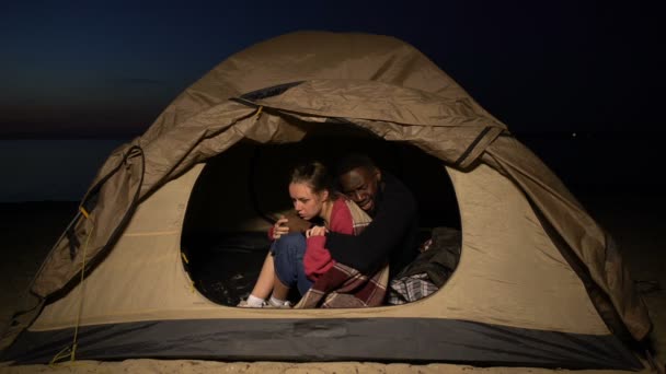 Depressed homeless couple hugging warming up in tent, loan debtors lost house — Stock Video