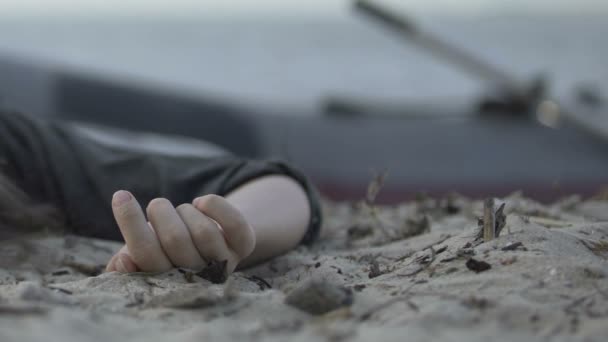 Close-up of dead woman hand lying on ocean coast after shipwreck, tragedy — Stockvideo