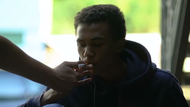 Éclairage à la main cigarette pour adolescent noir, habitude d'âge maladroit, fumer — Video