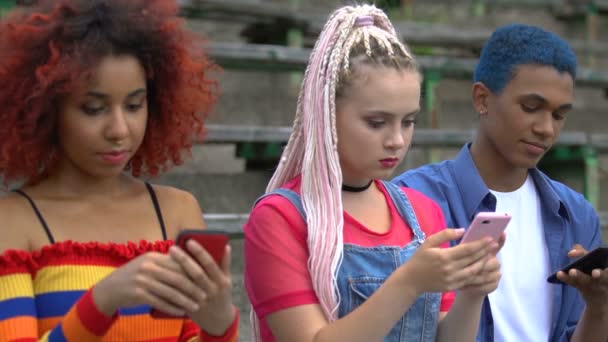 Stijlvolle tiener meisje delen van nieuwe app met multiraciale vrienden negeren van haar, gadgets — Stockvideo