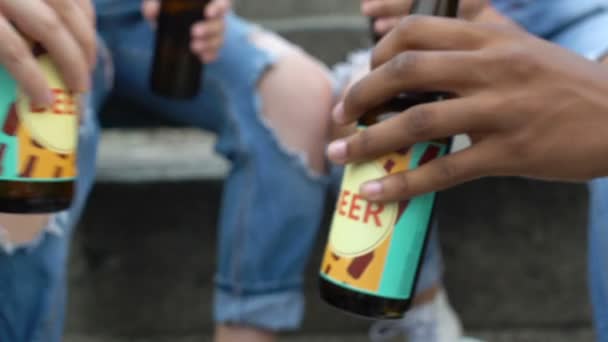 Young people clinking bottled beer outdoor, harmful alcohol addiction, closeup — Stock Video