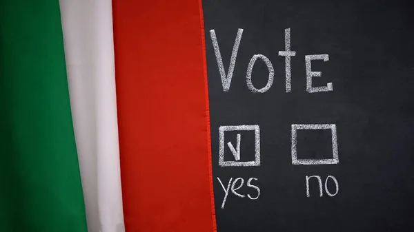 Italian flag on blackboard, yes answer marked in vote, president election, poll