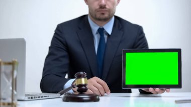 Confident lawyer holding tablet with green screen, attorney service online