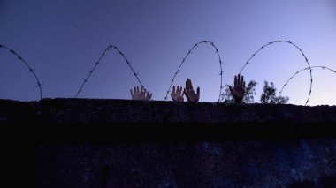 Children and adult hands behind barbed wire, forced settlements, refugee camp clipart