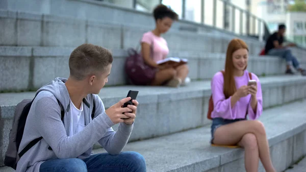 Millennial Caucasiano Com Smartphone Olhando Com Interesse Para Muito Adolescente — Fotografia de Stock