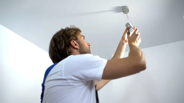 Professional Electrician Twisting Bulb Installing Light Apartment Service — Stock Photo, Image