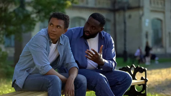 Black Teenager Male Ignoring Scolding Dad Sitting Campus Bench Conflict — Stock Photo, Image